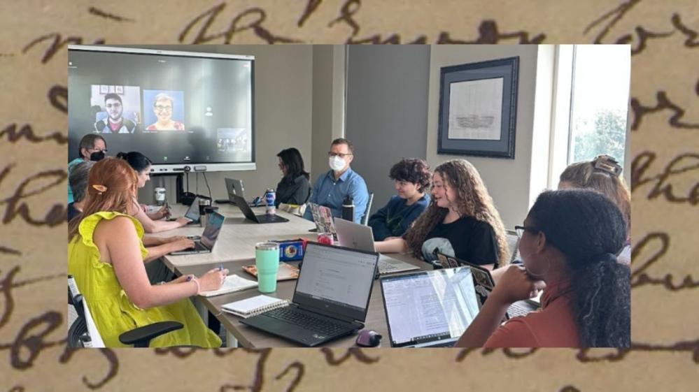 A photograph of part of the PRINT team at a team meeting. The photograph is bordered by one of the letters in the PRINT portal.